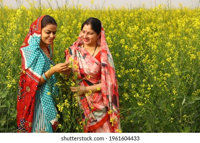 Indian rural ladies enjoying in mustard filed  - Shutterstock ID 1961604433