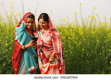 Indian rural ladies using phone in village