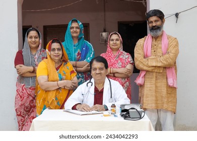 Indian rural people standing doctor in village
