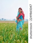 Indian rural woman standing at agriculture field