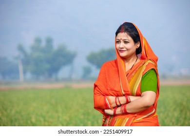 Indian rural woman in traditional saree at agriculture field.