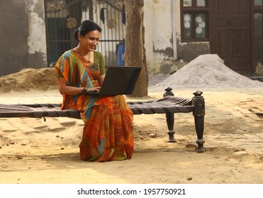 Indian rural women working on laptop in village
