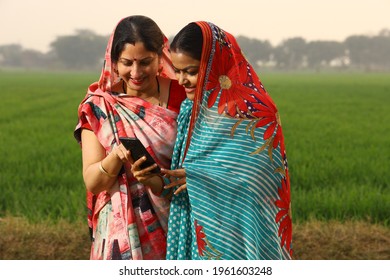 Indian rural women's looking phone in village  - Shutterstock ID 1961603248