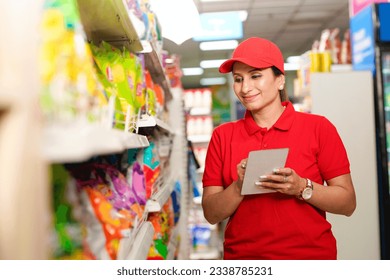 Indian saleswoman or manager checking stock at supermarket. - Powered by Shutterstock