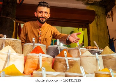 indian sallerman showing his small shop on arambol goa market - Powered by Shutterstock