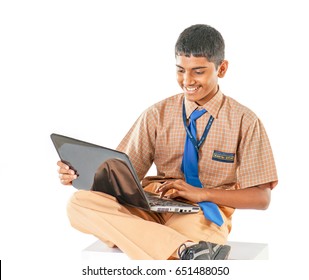 Indian School Boy Doing Study On Laptop, Isolated On White Background, Mumbai, Maharashtra, India, Southeast Asia.