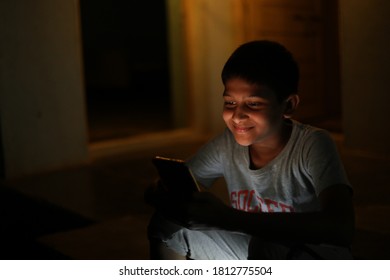 Indian School Boy Holding Phone Distance Learning Class Using Mobile Application, Watching Online Lesson, Video Calling In App 