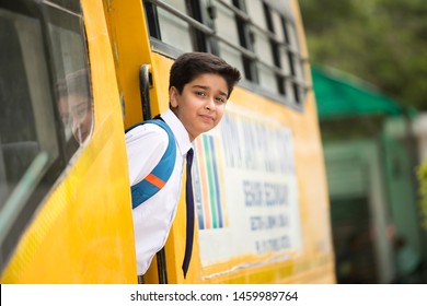 Indian Schoolboy Getting Into The School Bus