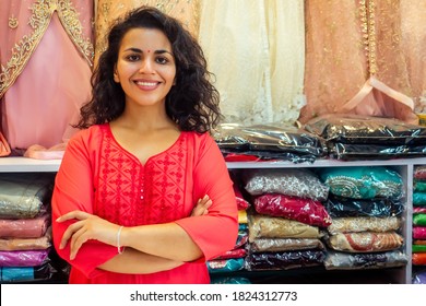 Indian Seller Women In Red Kurta Stand In Her Studio Showroom