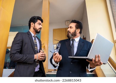 Indian senior businessman angry on his manager after looking in laptop - Shutterstock ID 2268815043