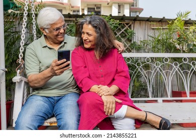 Indian Senior Couple  Enjoying Each Other Company In Garden, Retirement Life