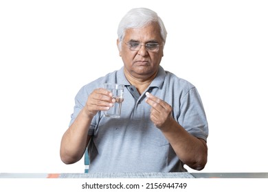 Indian Senior Man Taking Medicine 