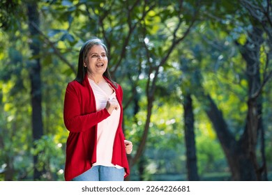 Indian senior woman doing exercise or jogging at park. - Powered by Shutterstock