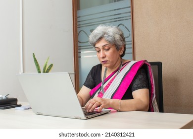 Indian Senior Woman In Ethnic Wear At Office Working On Laptop
