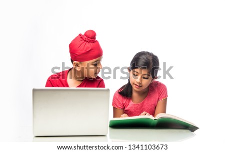 Indian sikh/Punjabi  boy and girl studying with books and laptop computer at study table Stock fotó © 