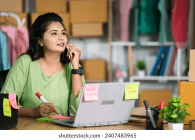 Indian small businesswoman office busy planning business or sales growth at ecommerce warehouse - concept of brainstorming, workplace strategy and productivity - Powered by Shutterstock