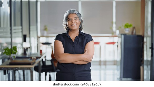 Indian smiling middle aged business woman cross arms look camera do pose for head shot portrait video at workplace. Elder old gen x female worker standing proud confident fold hand indoor office place - Powered by Shutterstock