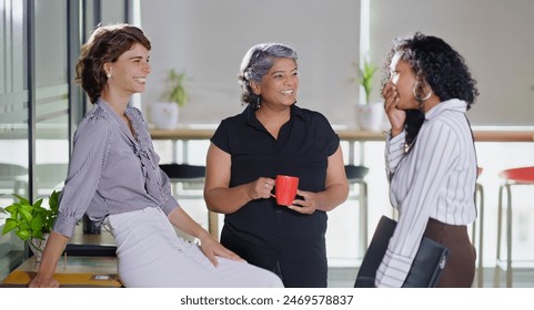 Indian smiling old business women standing hold cup drink coffee talk gossip indoor work place. Beautiful young adult corporate girls make funny blab share ideas during tea break spend time job office - Powered by Shutterstock