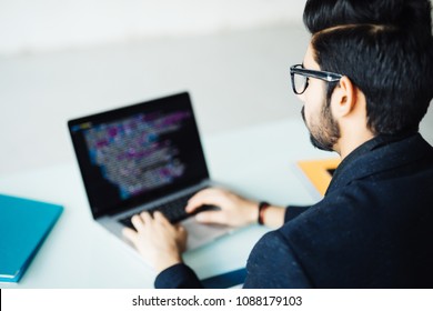 Indian Software Developer Working On Computer At His Office Table