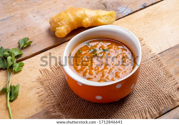Indian Soup puree of red lentils with ginger and\
parsley, flat lay.