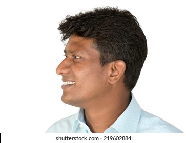 An Indian / South Asian Business Executive In A Light Blue Shirt Looking Away / Side Profile. Isolated On White Background.