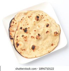 indian special flat bread also known as butter tandoori roti or naan, served in a white ceramic quarter plate