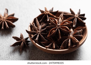 Indian spice whole stars anise in wooden plates on gray background - Powered by Shutterstock