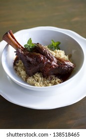 Indian Spiced, Braised Lamb Shank Over Cous Cous.