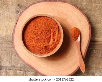 Indian Spices, Paprika Powder Or Red Chilli Powder In A Wooden Bowl With A Wooden Spoon, Selective Focus, To View