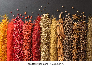 Indian spices are scattered on table. Spices for cooking as background. - Shutterstock ID 1583058472