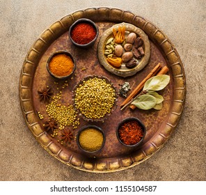 Indian Spices, seasoning and spicy in bowls on a copper tray, top view - Powered by Shutterstock