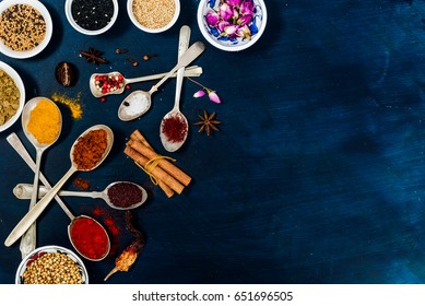 Indian spices selection over dark wooden table. Food or spicy cooking concept, Healthy eating Background. Top view of spices and herb with empty space for text. - Powered by Shutterstock