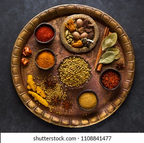 Indian spices, spicy and seasoning in bowls on a brass tray, top view - Powered by Shutterstock