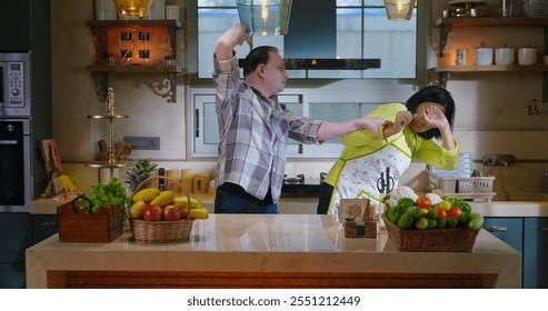 Indian stressed upset tense elder senior couple pair arguing fight shout feel bad hurt at modern house kitchen. Angry sad mature adult husband wife quarrel scream blaming on family problem indoor home - Powered by Shutterstock