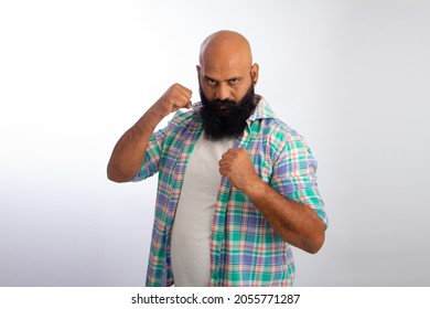 Indian Strong Healthy Middle Aged Bald Man Punching Fist To Fight, Aggressive And Angry Attack, Threat And Violence