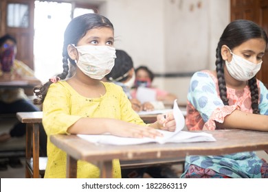 Indian Students Wearing Face Masks Sitting With Social Distancing At A Classroom As School Reopen During Covid19 Pandemic. New Strain Of Coronavirus, Second Wave. 