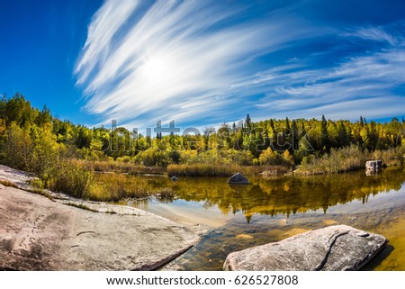 Indian summer in Manitoba, Canada. Incredible cirrus clouds over the Winnipeg River. Old Pinawa Dam Park. The concept of ecological and recreational tourism ストックフォト © 