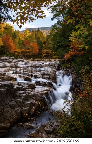 Indian Summer in New Hampshire, USA. A scenic view of the Swift river flowing during autumn.