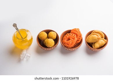 Indian Sweets Gujiya, Motichoor Laddu And Jalebi And Clarified Butter / Indian Desi Ghee In A Jar, Selective Focus
