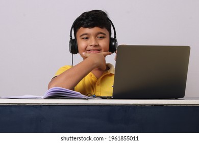 Indian syudent or kid attending online school using computer studying using laptop.  - Powered by Shutterstock