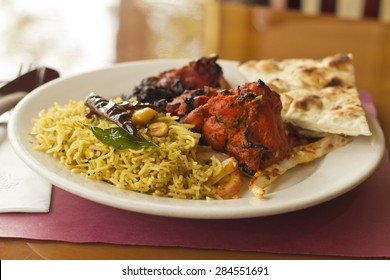 Indian tandoori chicken with fresh naan and tamarind rice