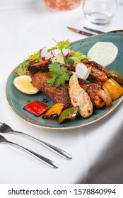 Indian Tandoori Starters Platter - Chicken Tikka, Malai Tikka, Lamb Chops Served With Peppers, Salad, Chutney And Garnish