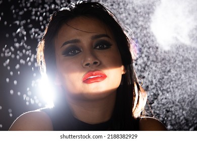 Indian Tanned Skin Asian Woman Show Face Make Up With Backlit Light And Water Splash Spray. Shadow Silhouette Female Head Express Feeling Dramatic Over Beautiful Elegance Black Background Copy Space