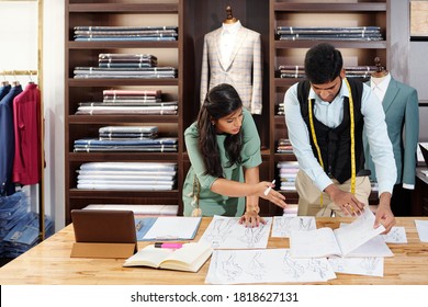 Indian team of fashion designers discussing ideas for new collection - Powered by Shutterstock