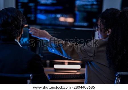 Indian technical lead explaining complex code structures and AI model inference parameters to a Brazilian colleague during a programming sprint.