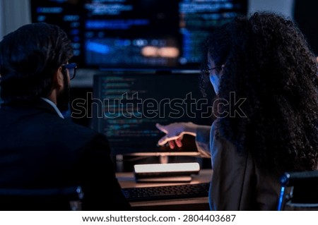 Indian technical lead explaining complex code structures and AI model inference parameters to a Brazilian colleague during a programming sprint.