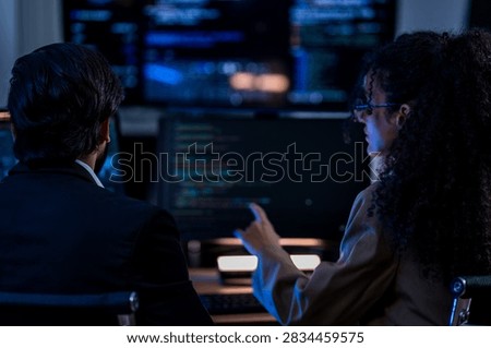 Indian technical lead explaining complex code structures and AI model inference parameters to a Brazilian colleague during a programming sprint.