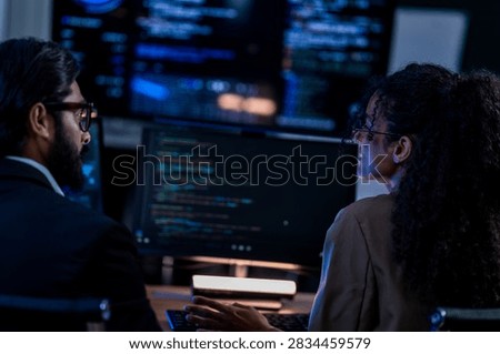 Indian technical lead explaining complex code structures and AI model inference parameters to a Brazilian colleague during a programming sprint.
