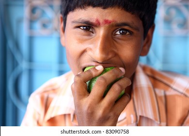 Indian Teen Boy Eating Fruit.