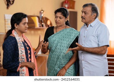 Indian teenager daughter arguing or fighting with parents at home - concept of family misunderstanding, conflict conversation and generation problems. - Powered by Shutterstock